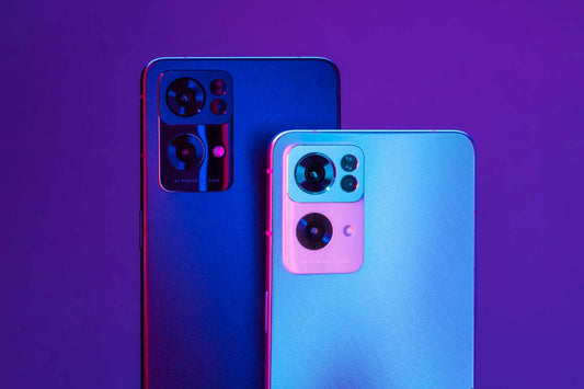 a close up of two cell phones near one another